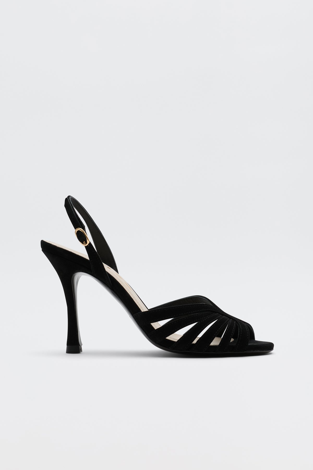 The Mavi - Black high-heeled sandal features an open toe, slim straps, a slingback with gold buckle, and a sleek heel—ideal for adding glamour to any look. Shown against a simple light backdrop.