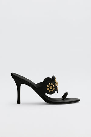 Esmeray - Black high-heeled sandal featuring a thin heel, open toe, and gold stud embellishments on the upper strap, displayed against a plain white background.
