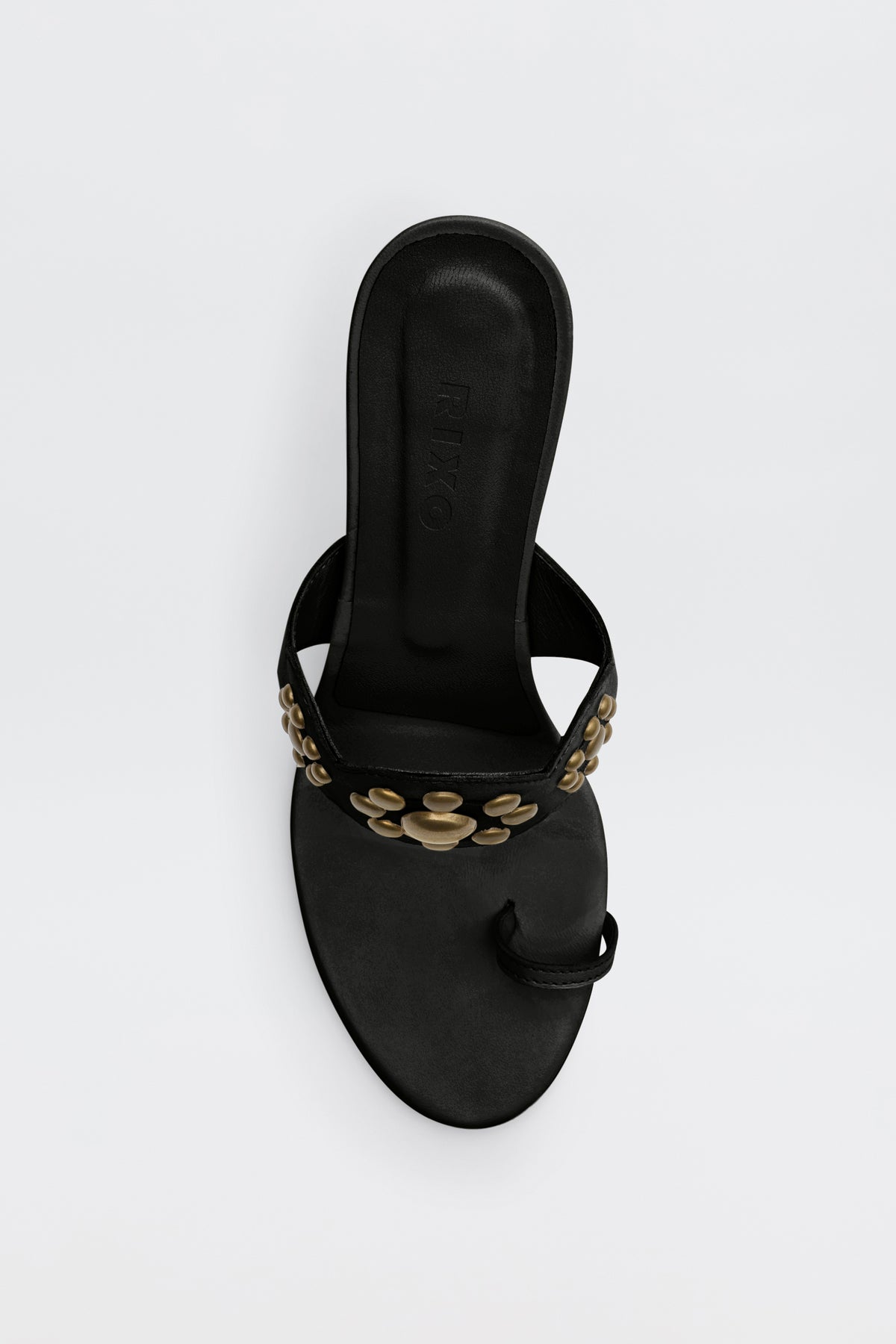 Rewritten Sentence: The Esmeray - Black sandal is a low-heeled, black sandal with a toe loop and gold circular studs embellishing the strap. It is photographed from above against a plain white background.