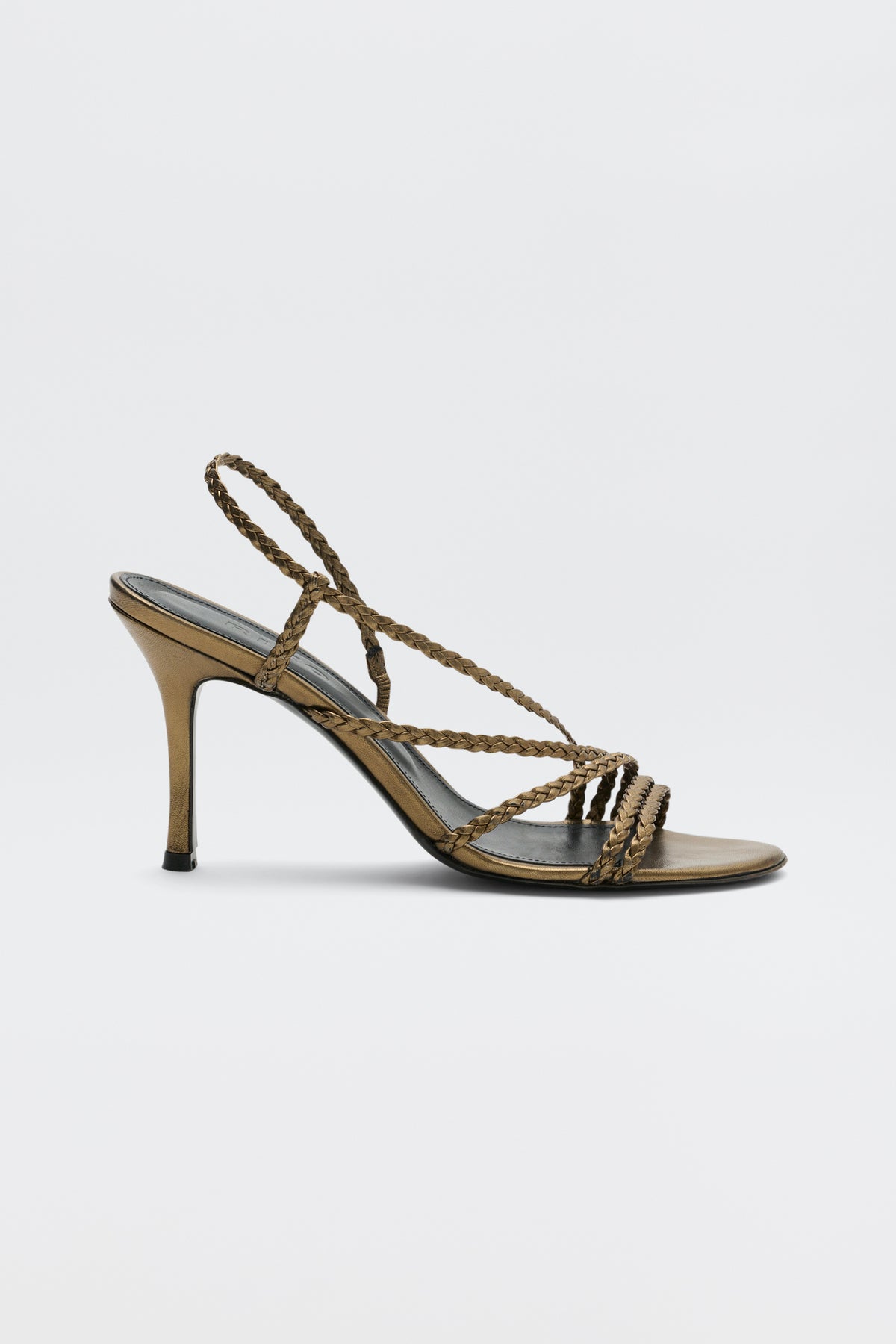 Gracey - Gold high-heeled sandal featuring braided straps that cross over the toes and wrap around the ankle, displayed in a side view against a plain white background.