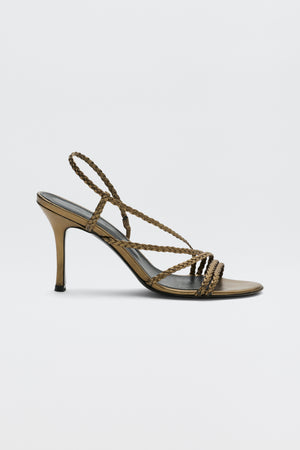 Gracey - Gold high-heeled sandal featuring braided straps that cross over the toes and wrap around the ankle, displayed in a side view against a plain white background.
