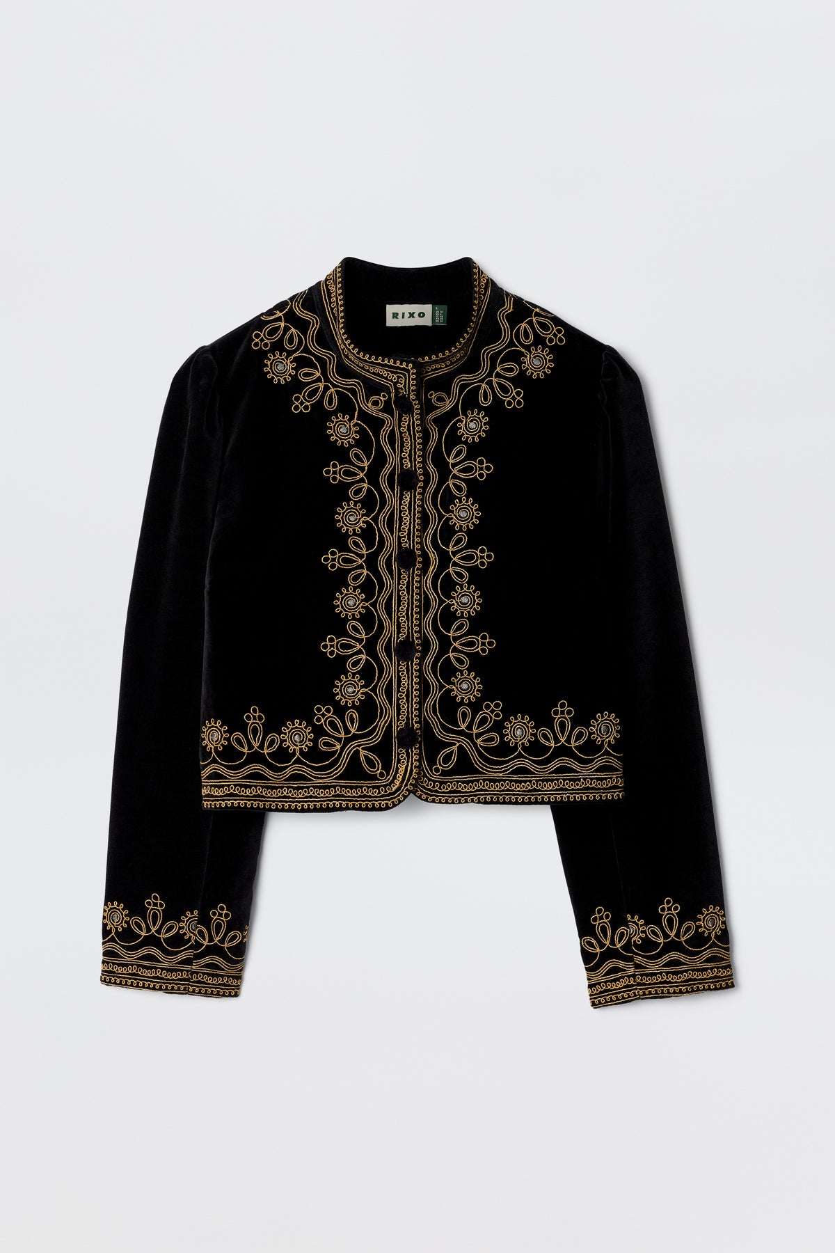 The Denver - Soutache Black jacket is crafted from soft cotton-velvet in black, detailed with gold embroidery on the collar, front opening, cuffs, and hem. Shown against a plain white background.
