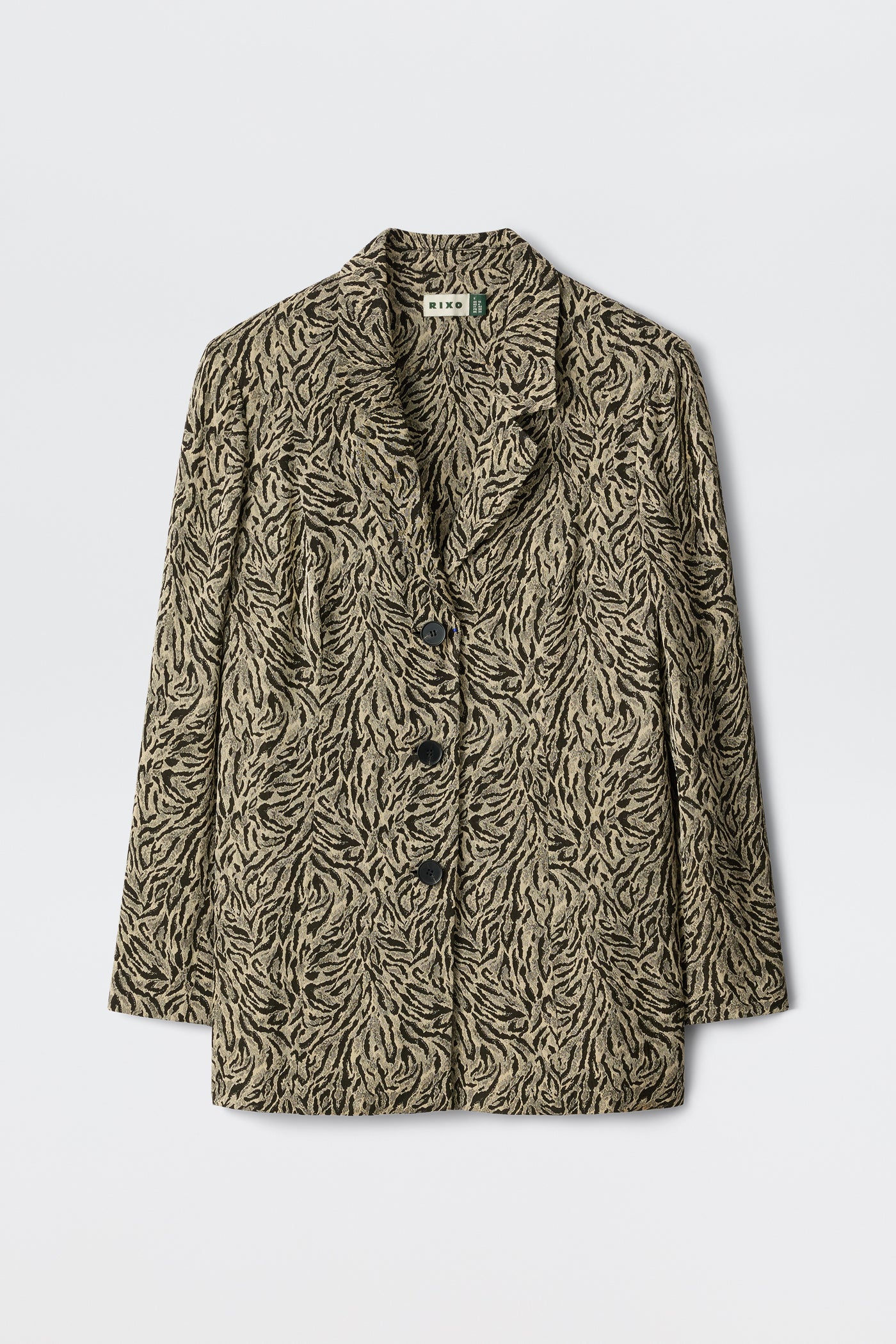 Marselle - Sun Leo Tan features a beige and black leaf-patterned blazer with three black buttons, notched lapels, and long sleeves, showcased on a plain white background.
