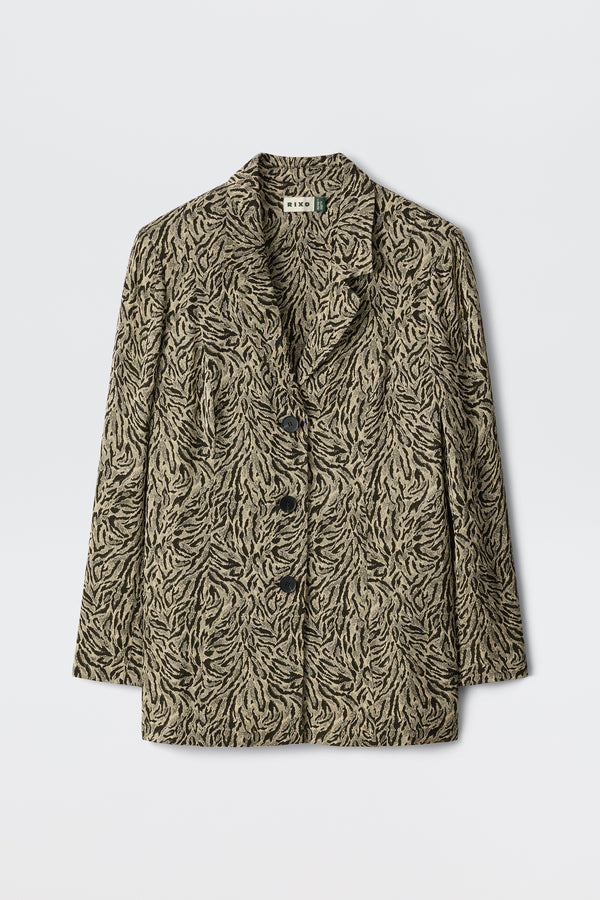 Marselle - Sun Leo Tan features a beige and black leaf-patterned blazer with three black buttons, notched lapels, and long sleeves, showcased on a plain white background.