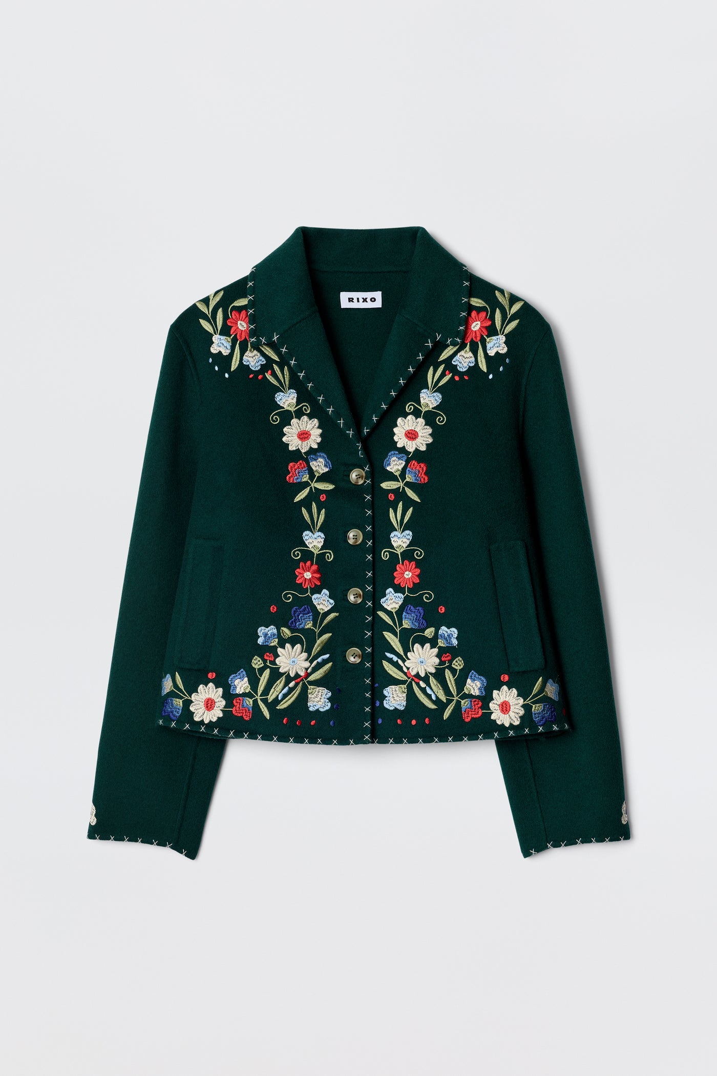 The Jude - Bliss Embroidery Green jacket by RIXO is a dark green, cropped piece with vibrant embroidery on the front, lapels, and cuffs, finished with decorative metallic buttons.