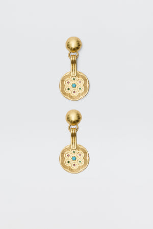 A pair of Anouk - Gold drop earrings with round, textured discs featuring a circular pattern and central colored gemstones, attached to smooth gold studs. Vintage-inspired, photographed on a plain white background.