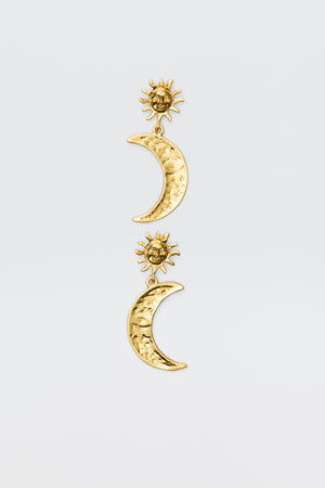 The Davies - Gold earrings feature gold-plated celestial charms: a textured crescent moon hangs from a detailed sun, creating a vintage-inspired look against a plain white background.