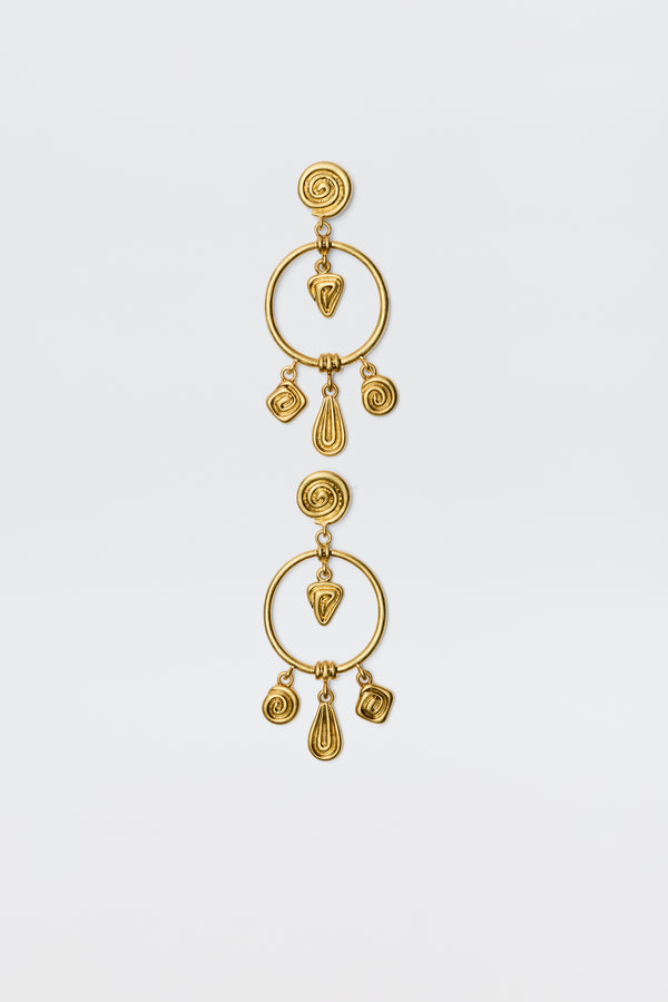 The Thome - Gold earrings feature circular posts, large open hoops, and dangling spiral and teardrop geometric charms for a bohemian look, shown against a plain white background.