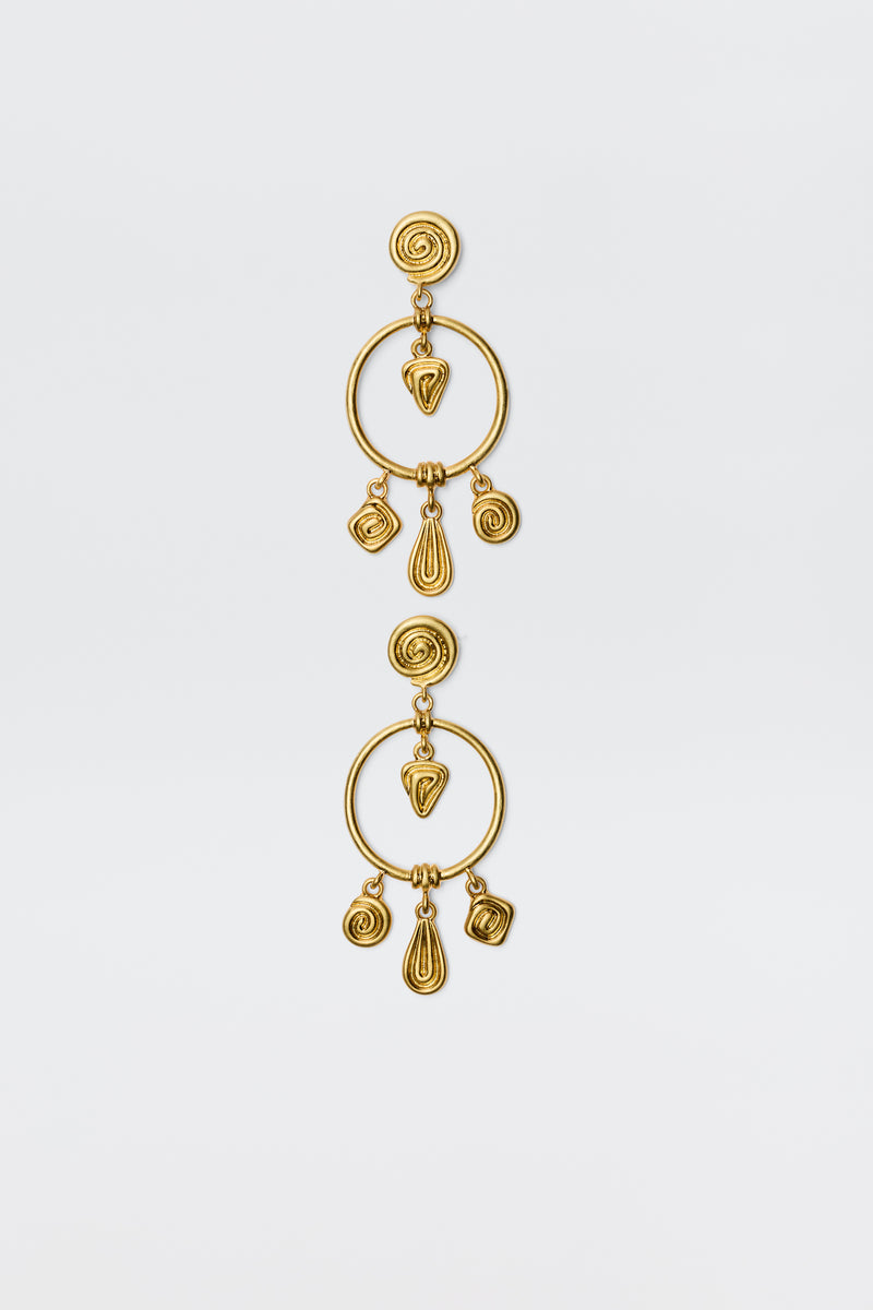 The Thome - Gold earrings feature circular posts, large open hoops, and dangling spiral and teardrop geometric charms for a bohemian look, shown against a plain white background.