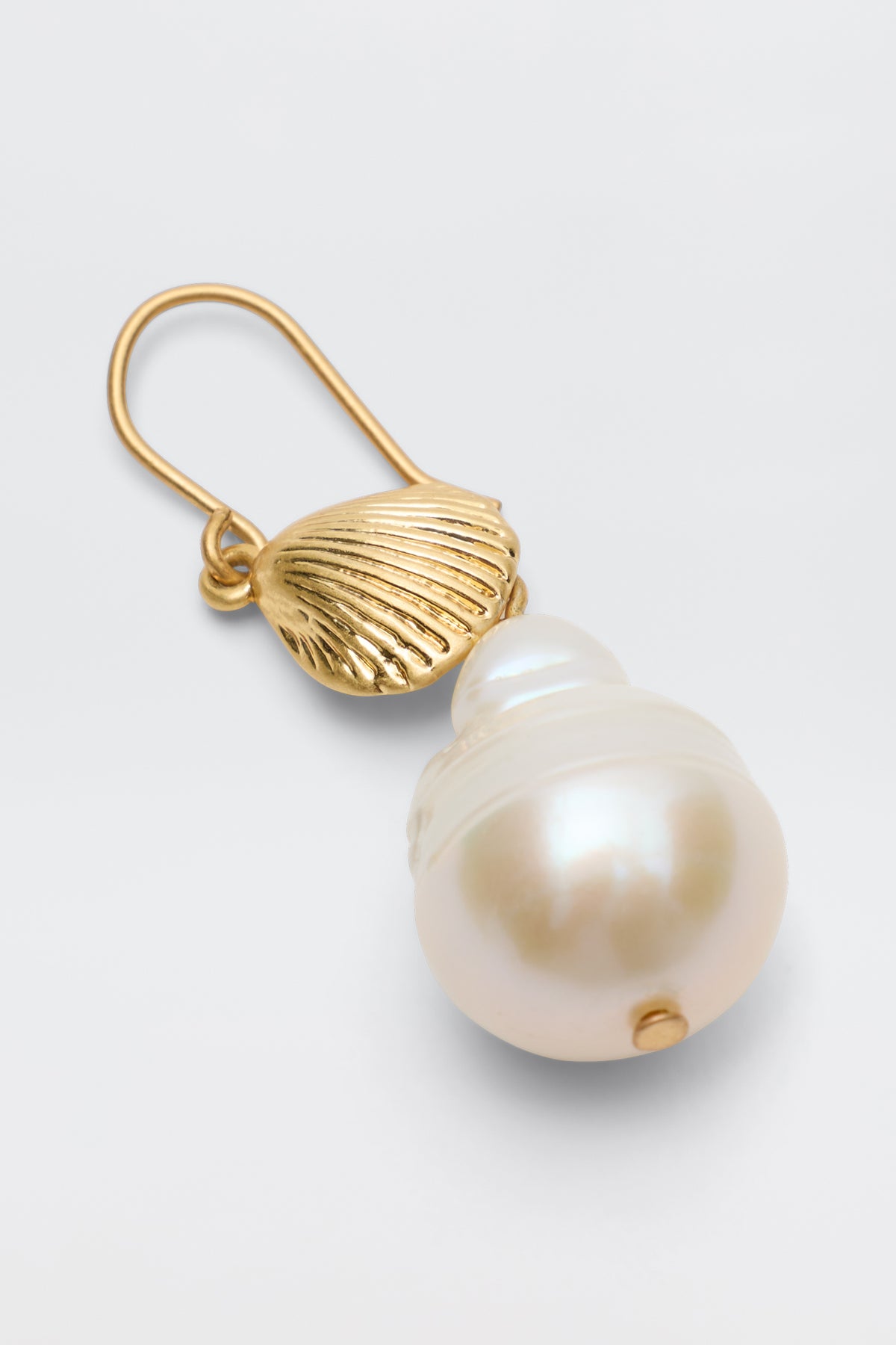 The Rosaria - Gold earring features a gold-plated shell-shaped top with a large round white resin pearl drop, displayed against a plain light background.