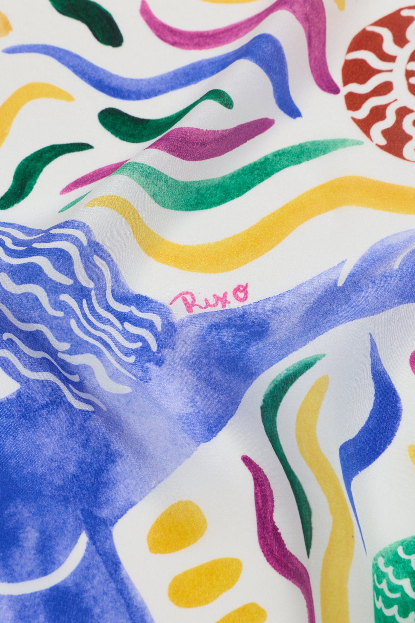 A close-up of colorful abstract patterns on fabric, with wavy lines and shapes in blue, yellow, green, and red, featuring "Menno - Mythos Iris Ivory" in pink script near the center.