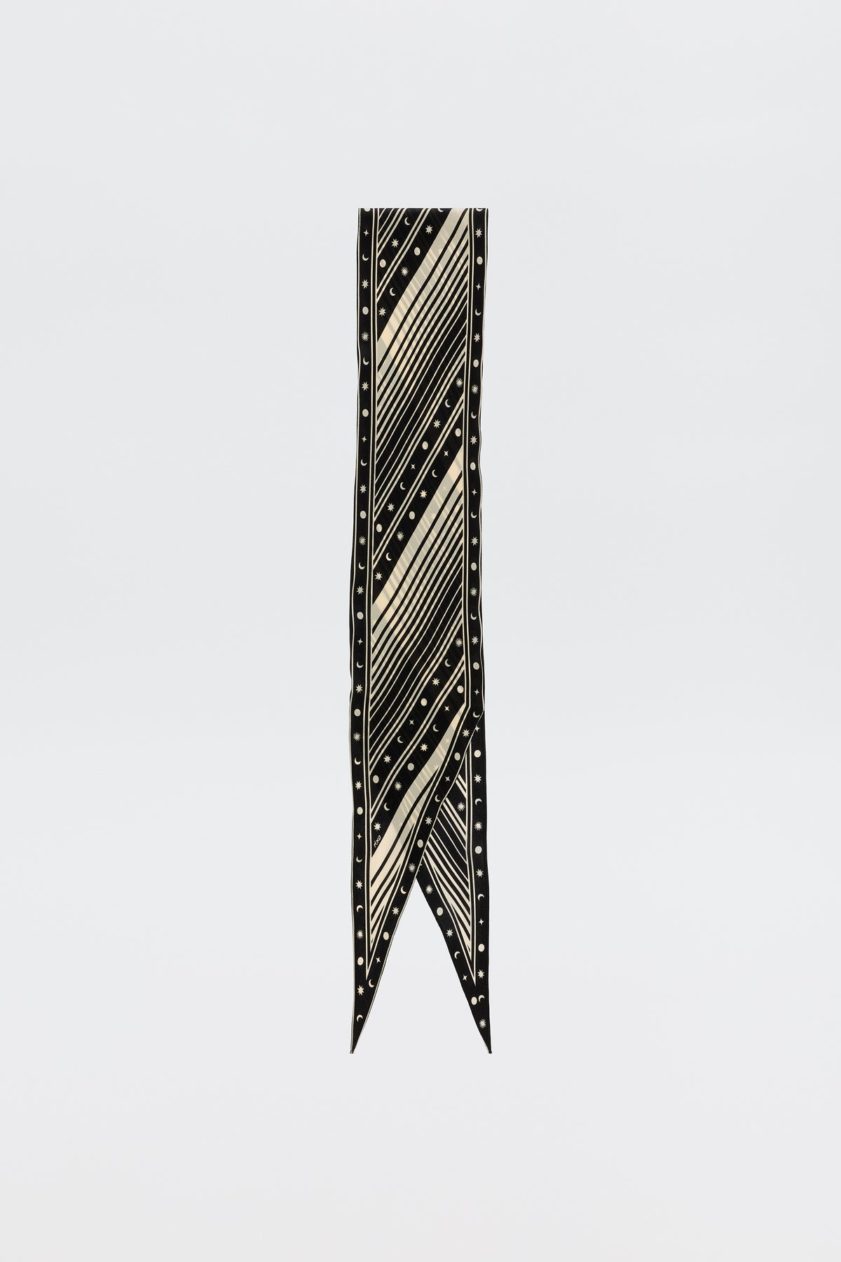 The Nara – Starstruck Black is a long, narrow pure silk scarf with cream diagonal stripes and small dots, finished with a pointed V-shaped tip, shown on a plain white background.