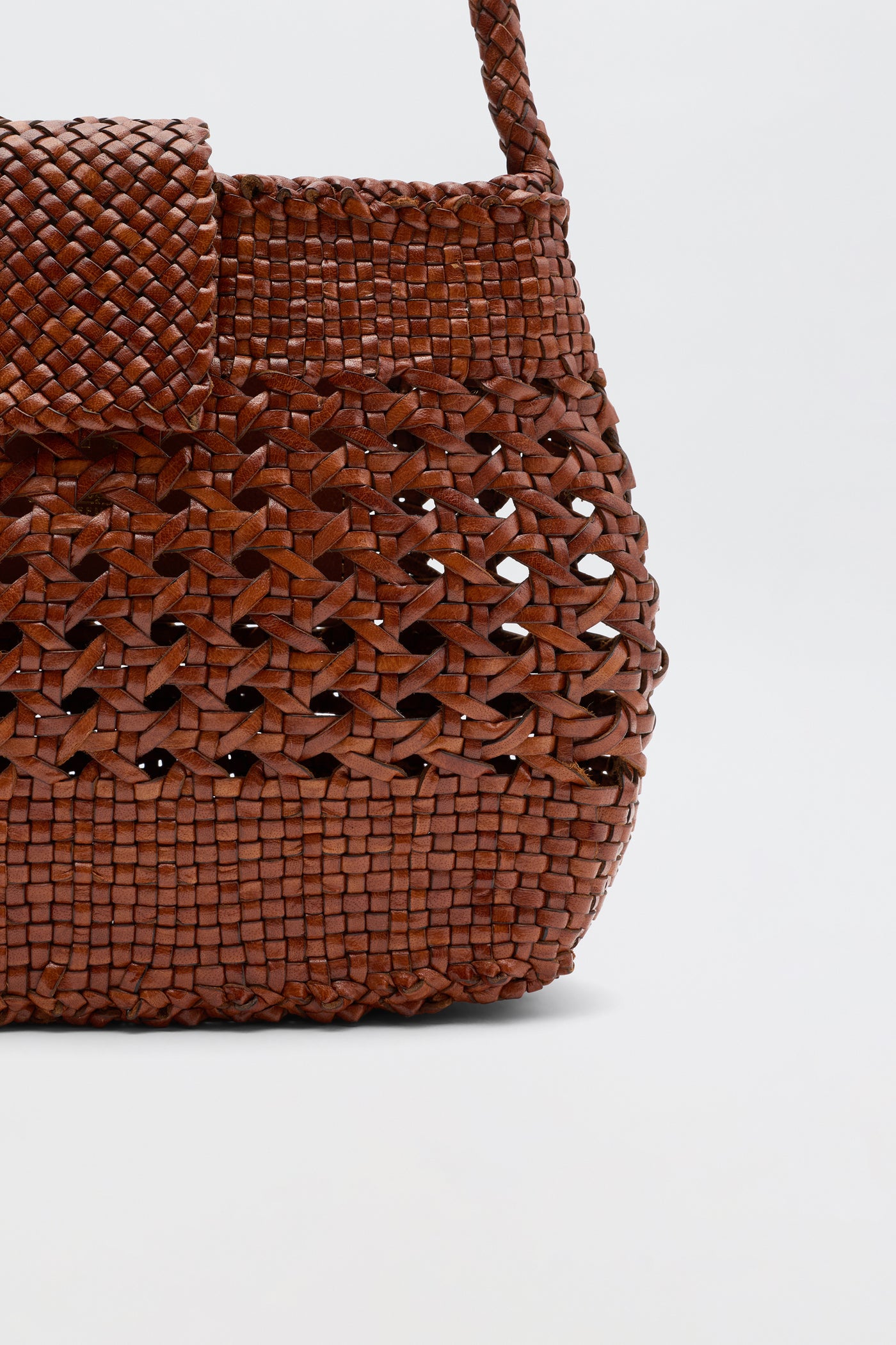 Close-up of the Amoria - Tan handbag by Dragon Diffusion, featuring a mix of tight and open weaves that highlight its vintage-inspired craftsmanship, shown against a plain white background.