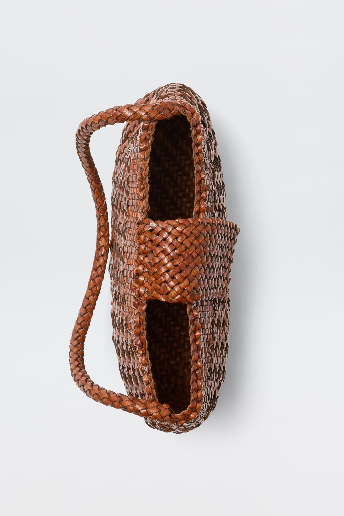 A top-down view of the Amoria - Tan basket, featuring a vintage-inspired woven design and a single thick handle made from the same material, set against a plain white background.