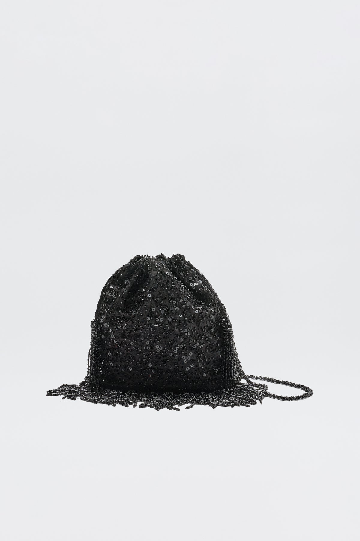 The Orla Vintage Scatter Embellishment Black is a small black beaded drawstring pouch purse with decorative fringes, shown against a plain white background.