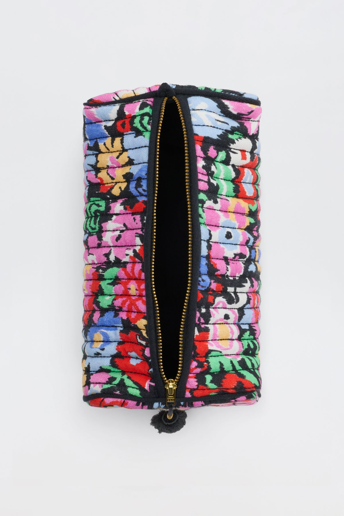The Jadina - Ikat Bloom Charcoal is a rectangular fabric pouch with a colorful floral pattern and a central gold zipper, partially open, set against a plain white background.