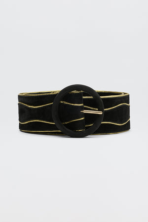 The Catalina - Black and Gold is a sueded cow leather belt with subtle gold wavy lines and a large round black buckle, shown against a plain light background.