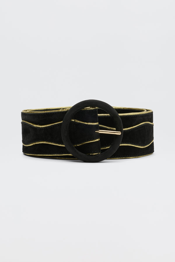 The Catalina - Black and Gold is a sueded cow leather belt with subtle gold wavy lines and a large round black buckle, shown against a plain light background.