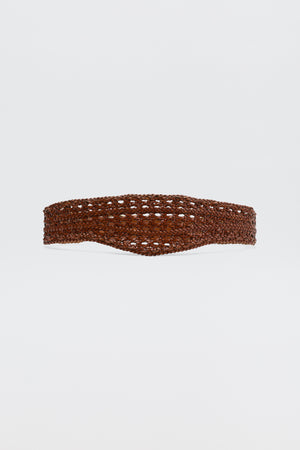 The Roxella - Tan belt, featuring a wide design and intricate open-weave pattern in brown, is displayed against a plain white background.