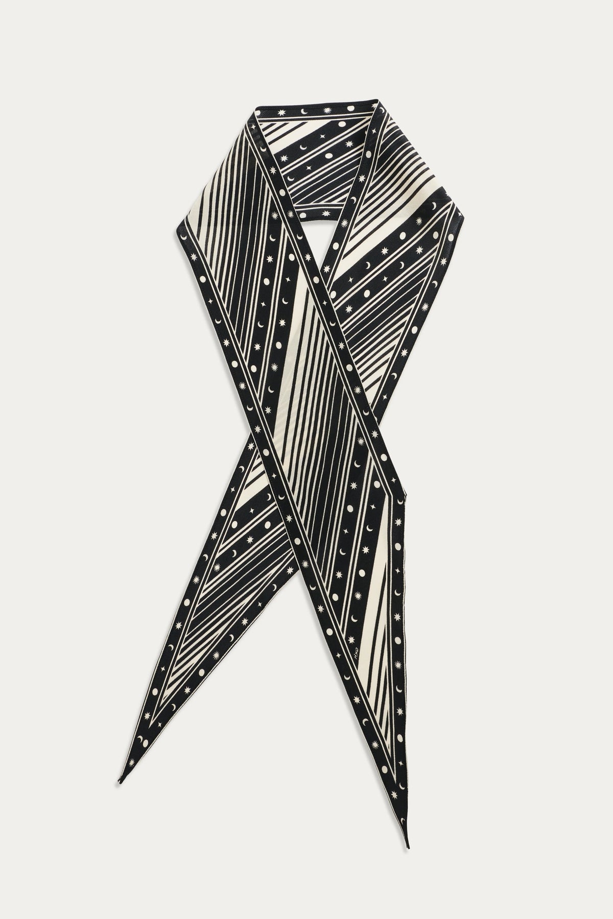 The Yelina - Starstruck Black silk scarf is displayed in a crisscross layout, highlighting its bold black and white diagonal stripes and small polka dots against a white background.