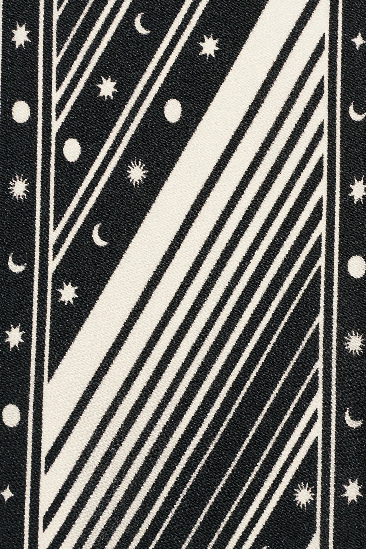 Bold black and white geometric pattern with diagonal lines, crescent moons, stars, and circles in a celestial motif—ideal for a statement silk scarf like the Yelina - Starstruck Black.