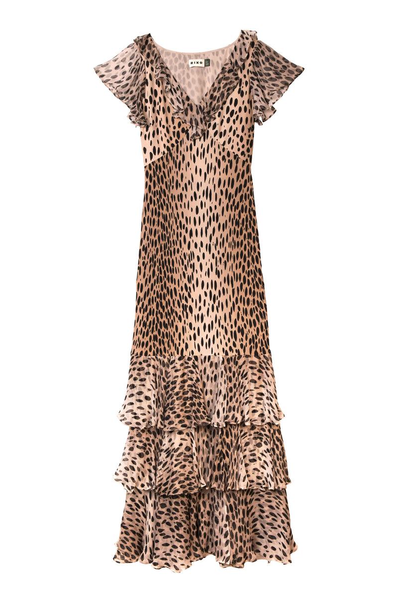 The Amelle - Antelope Spot Black is a sleeveless, v-neck silk crepe de chine dress with ruffled cap sleeves, layered ruffles at the hem, and a tan and black animal print pattern.