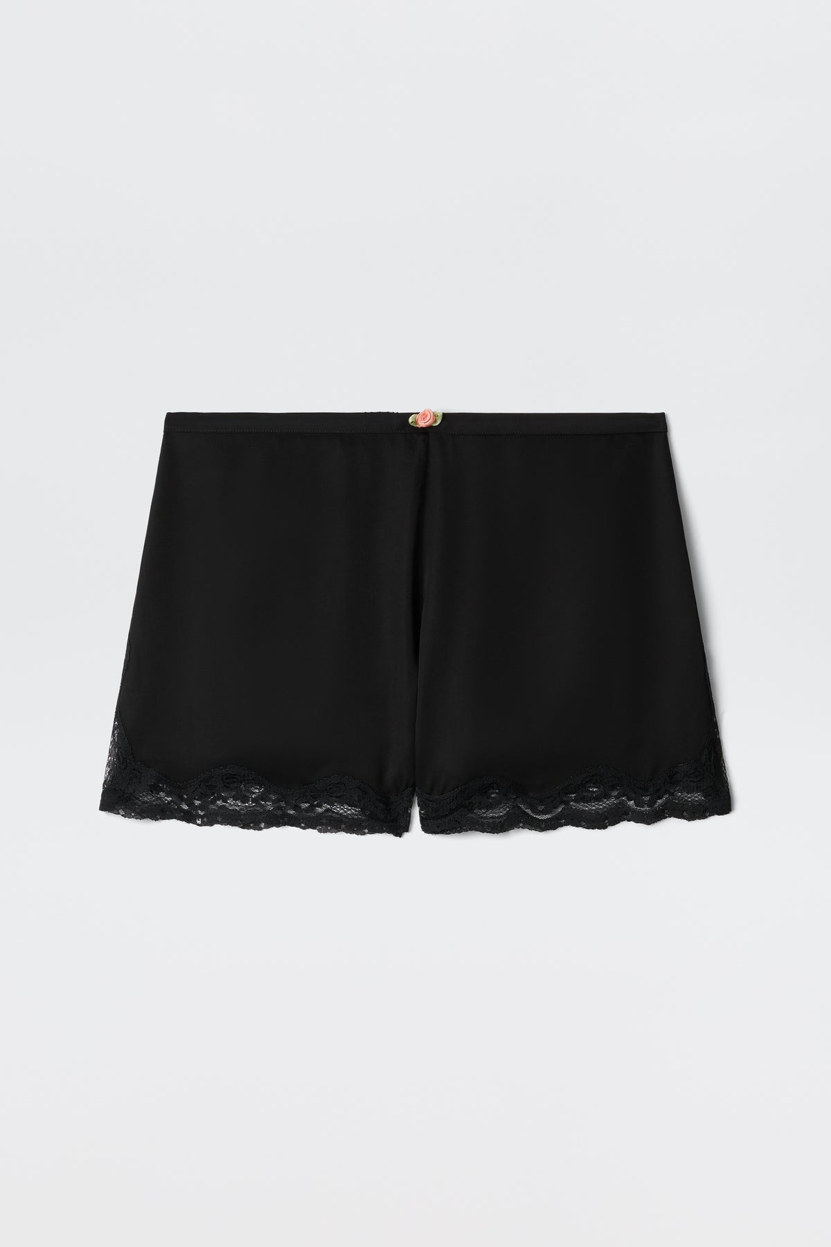 Lealia - Black satin shorts featuring a lace-trimmed hem and a delicate rose detail at the waistband, shown on a plain white background.