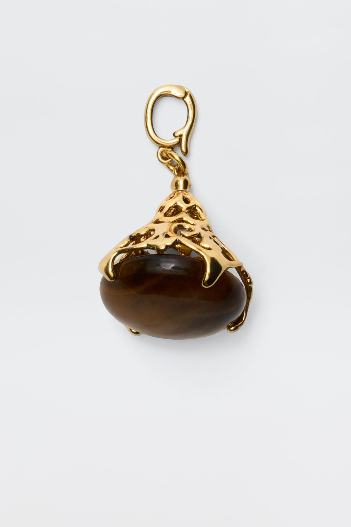 The Maella - Gold pendant features a brown oval tiger's eye stone set in an ornate 18K gold-plated setting with a top loop for necklace attachment, shown against a plain white background.
