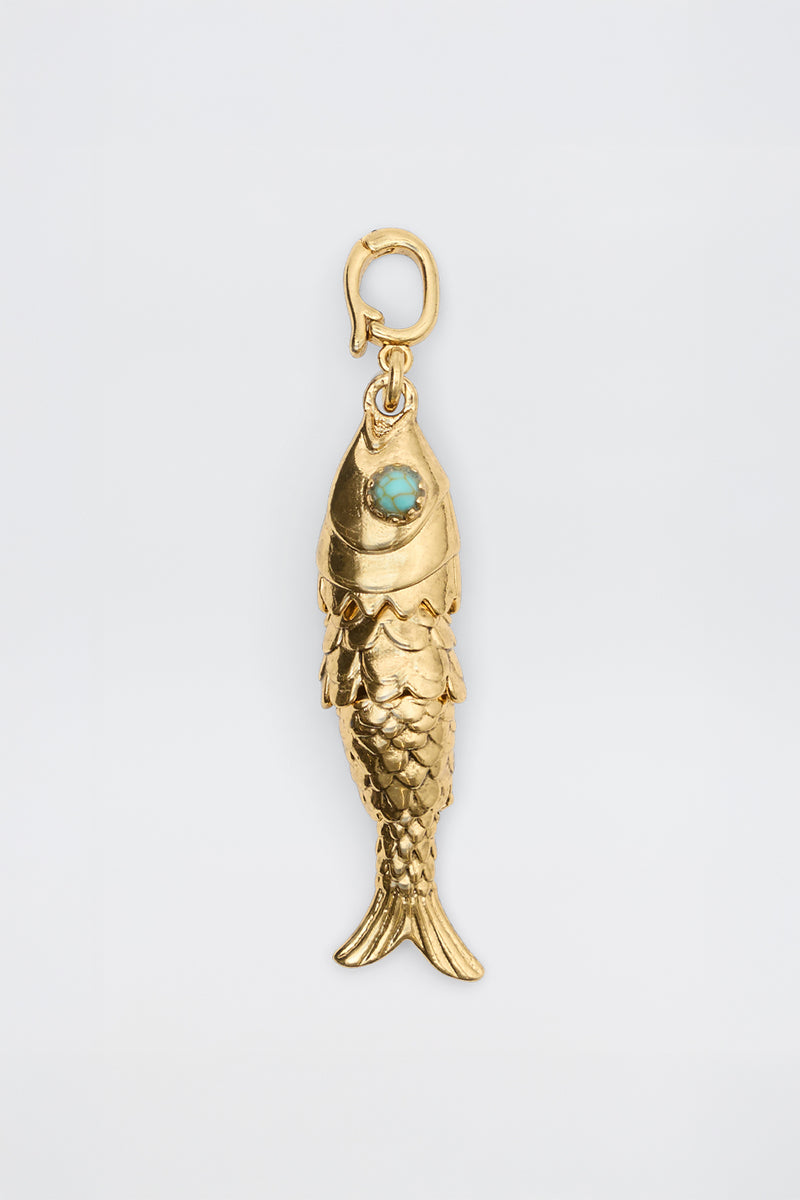 Nerissa - Gold: Fish-shaped pendant featuring detailed scales, a turquoise-colored eye stone, and a small top clasp for attaching to a chain, displayed on a plain white background.
