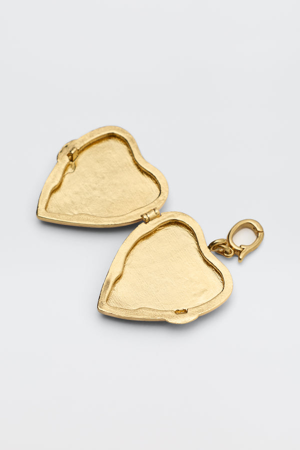 The Ardina - Red heart-shaped locket, featuring two empty compartments and a small clasp for chains, is displayed on a simple light background.