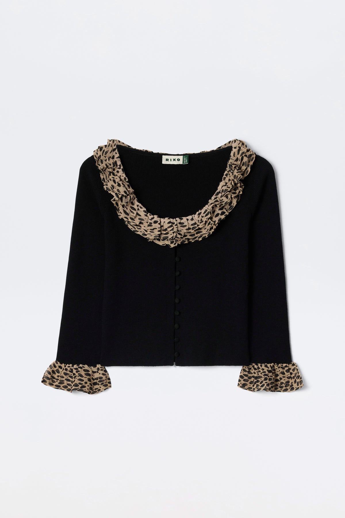 The Laurel - Antelope Spot Black is a black merino wool cardigan with wide ruffled leopard-print trims at the collar and matching cuffs, shown against a white background.
