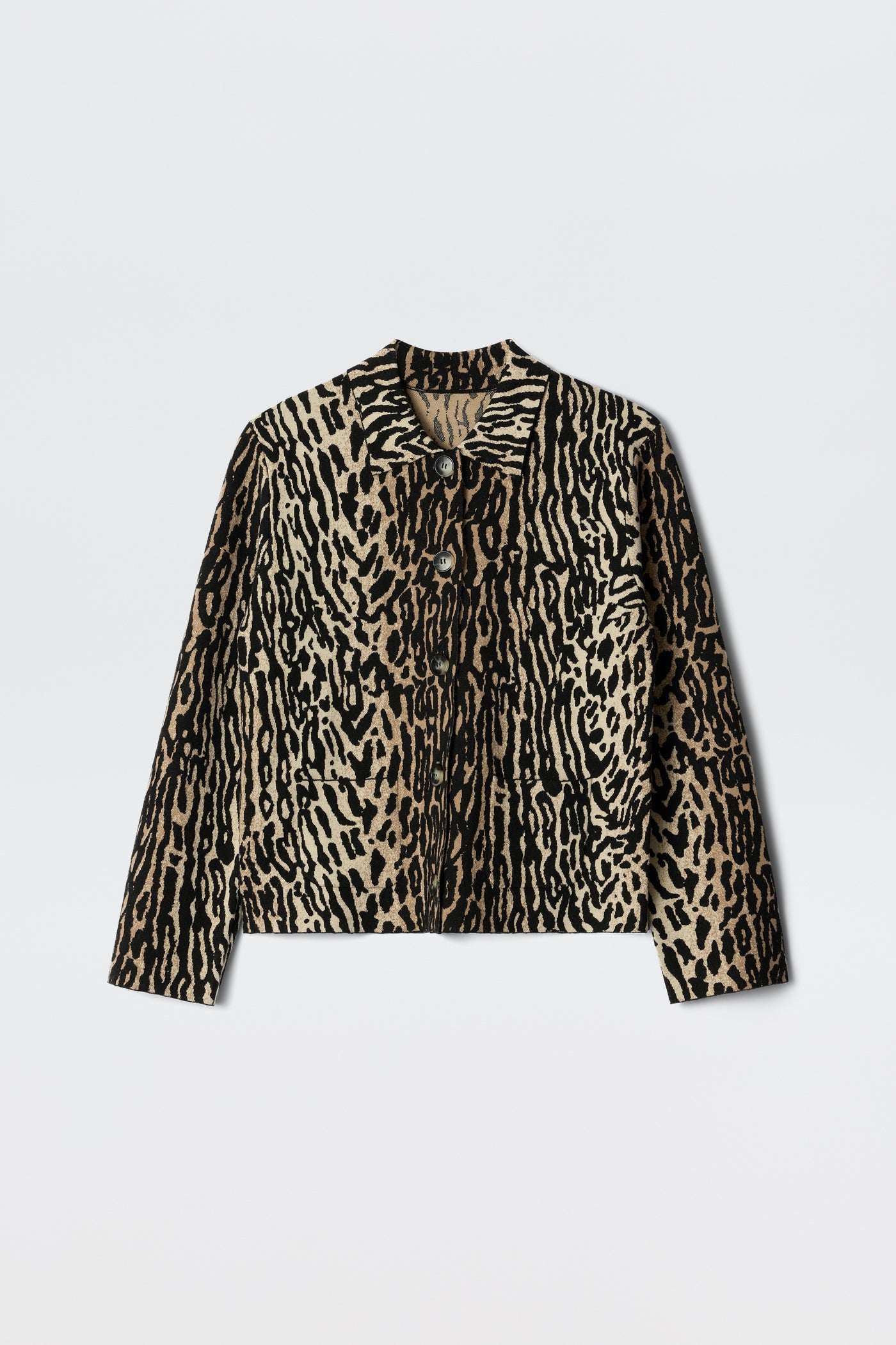 The Trista - Bohemia Leopard Brown is a long-sleeve jacket featuring a tan and black animal print, button-up front, collar, and two chest pockets, shown against a white background.