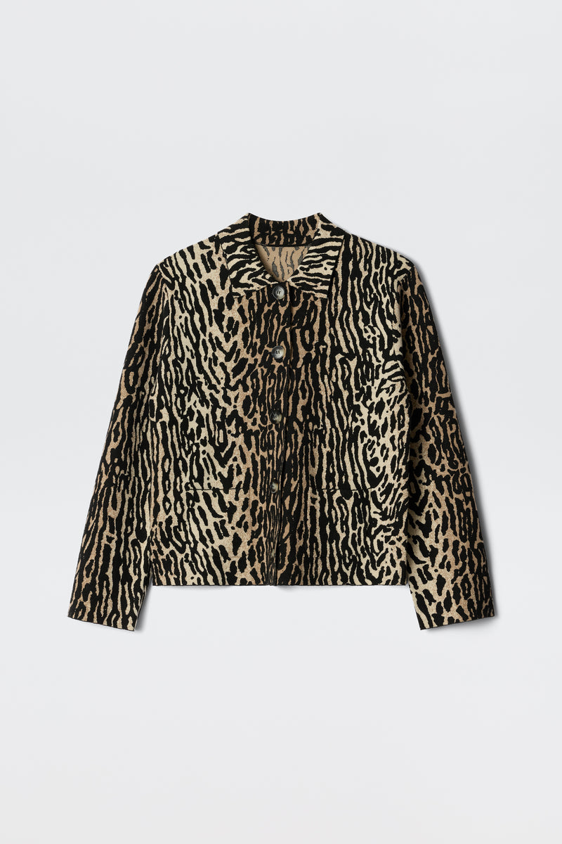 The Trista - Bohemia Leopard Brown is a long-sleeve jacket featuring a tan and black animal print, button-up front, collar, and two chest pockets, shown against a white background.