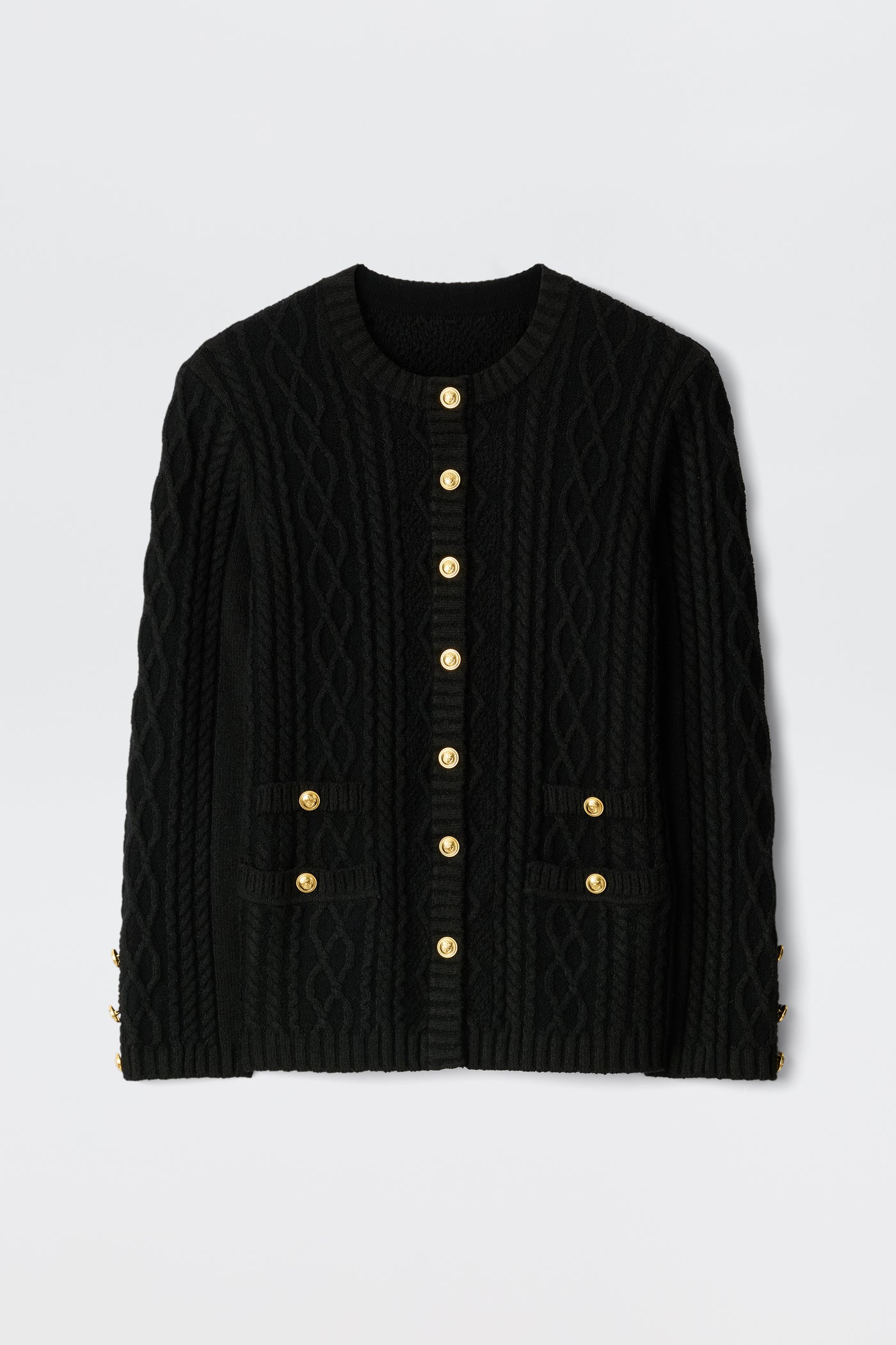 The Maurya - Black cable-knit cardigan features gold buttons down the front and on two front pockets, displayed flat against a plain white background.