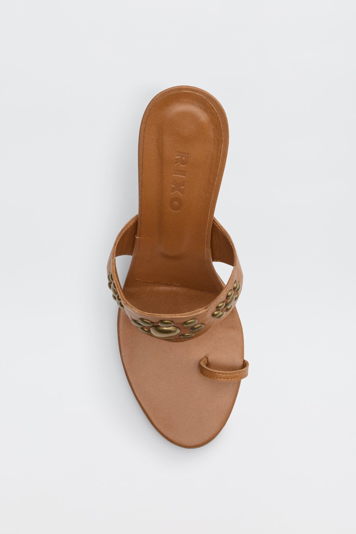 Top view of the Esmeray - Tan sandal, featuring a wide strap with gold floral embellishments and a single toe loop, displayed against a plain white background.
