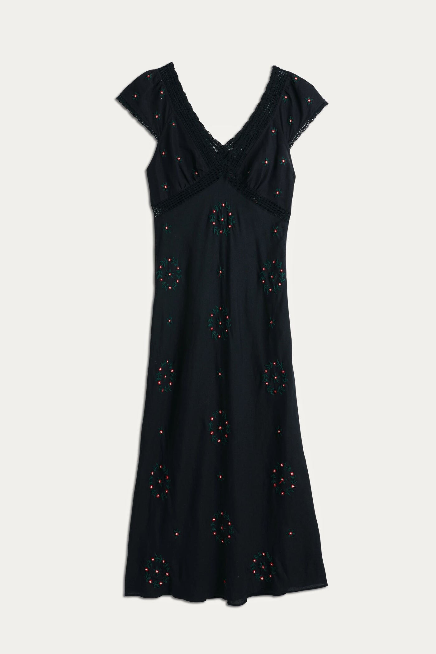 The Iggy - Rose Trail Embroidery Black dress features a black short-sleeve V-neck design with cotton lace trim and colorful beaded embroidery. Its fitted waist and gently flared skirt make it a versatile choice for any occasion.