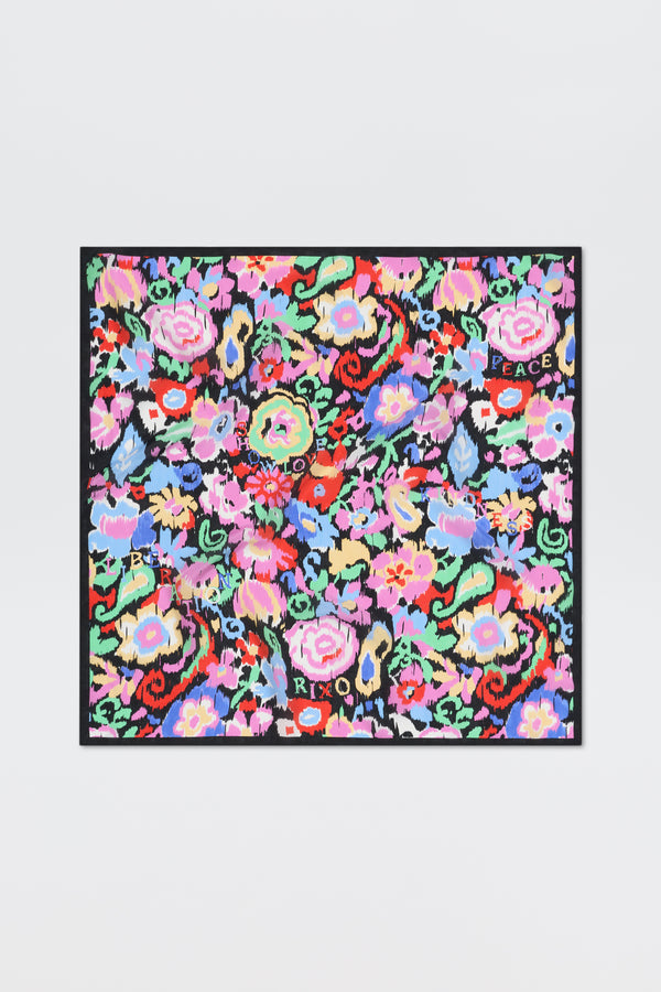 Introducing “Menno - Ikat Bloom”: a colorful square scarf featuring a vibrant floral pattern with words like LOVE, PEACE, and XOXO scattered among red, pink, blue, and green flowers on a black background.