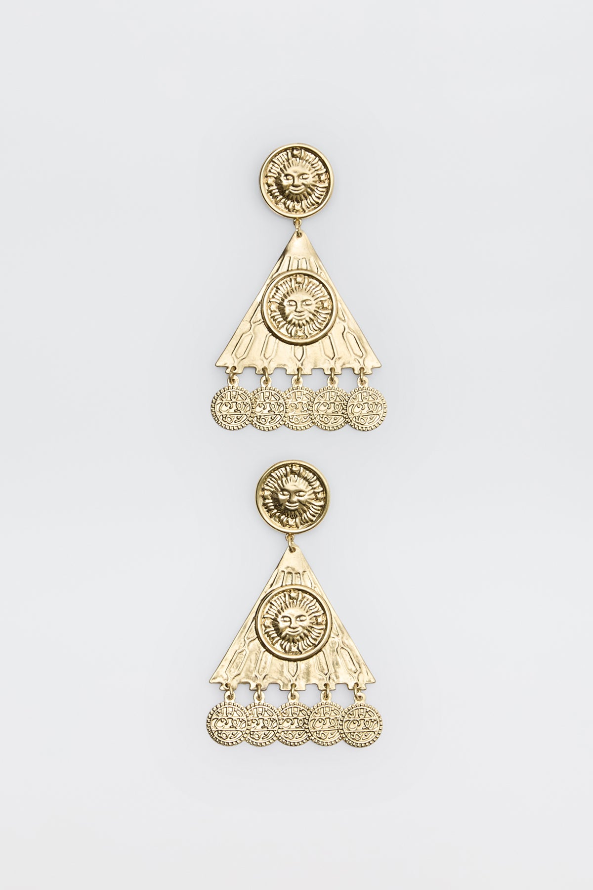 Two ornate gold earrings from the Miray - Gold collection, featuring circular sun motifs at the top, triangular sections, and dangling round charms. The intricate design is enhanced by engraved patterns and a lustrous, shiny finish, showcased against a plain white background.