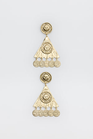 Two ornate gold earrings from the Miray - Gold collection, featuring circular sun motifs at the top, triangular sections, and dangling round charms. The intricate design is enhanced by engraved patterns and a lustrous, shiny finish, showcased against a plain white background.