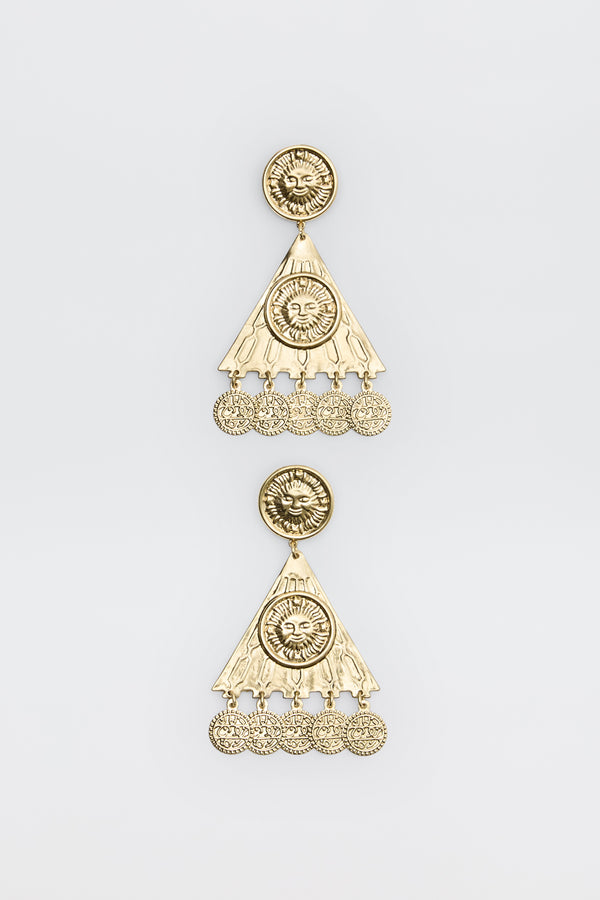 Two ornate gold earrings from the Miray - Gold collection, featuring circular sun motifs at the top, triangular sections, and dangling round charms. The intricate design is enhanced by engraved patterns and a lustrous, shiny finish, showcased against a plain white background.