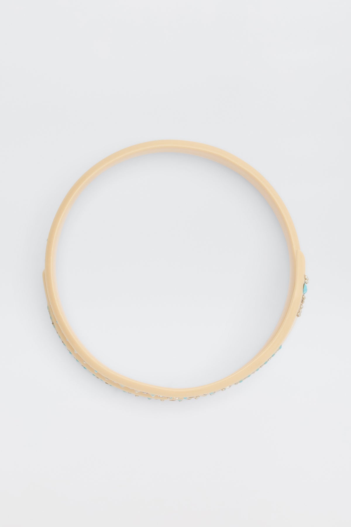 The Shereen - Cream is a beige circular bangle bracelet with a smooth finish, shown on a plain white background.