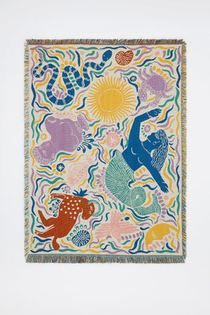 The Athena Throw - Ivory from the Mythos Collection is a recycled cotton tapestry featuring abstract sea creatures, a blue Greek-inspired mermaid, swirling vibrant shapes, and a decorative fringed border.